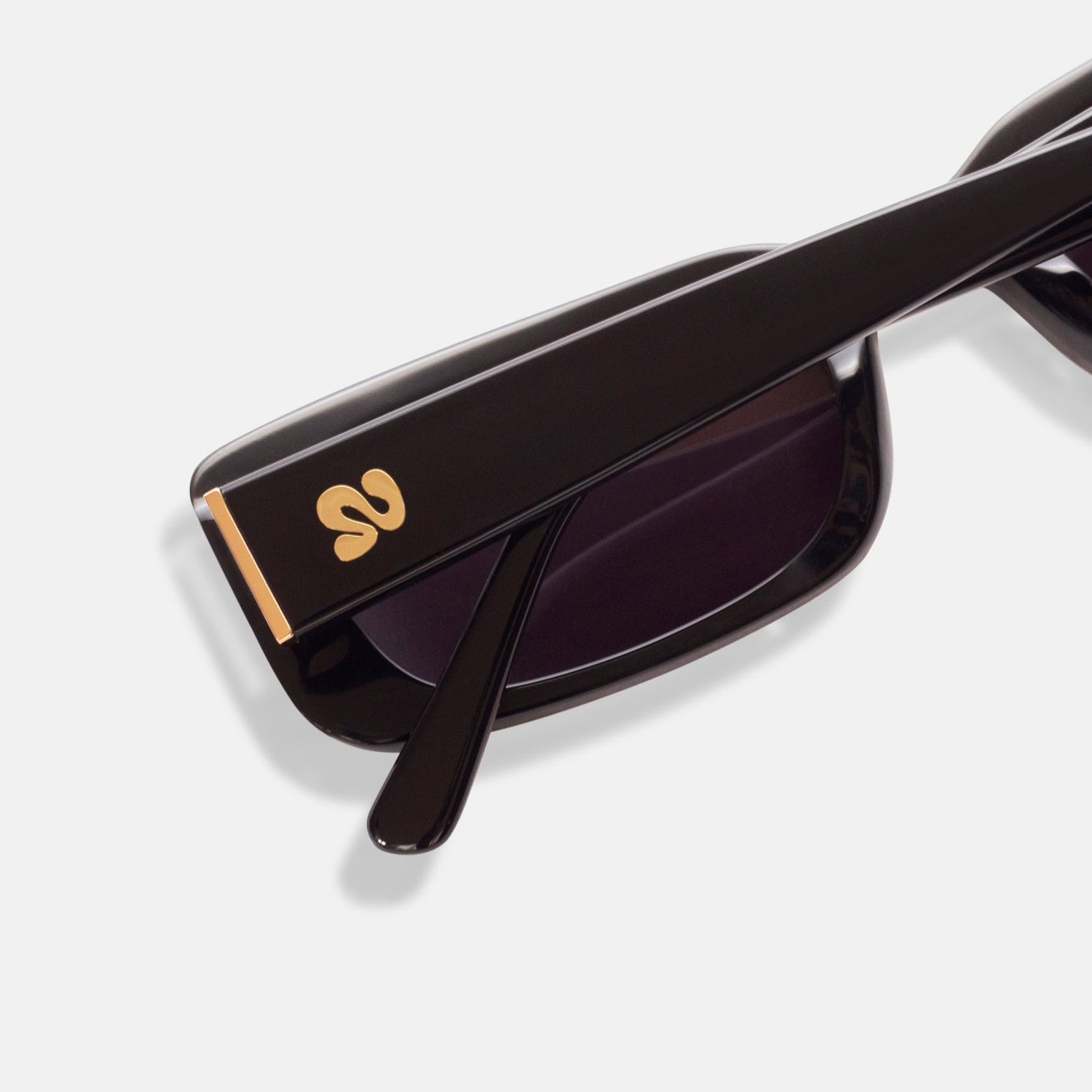 Close-up of Isla Sunwear logo on black rectangular sunglasses, designed for smaller faces.