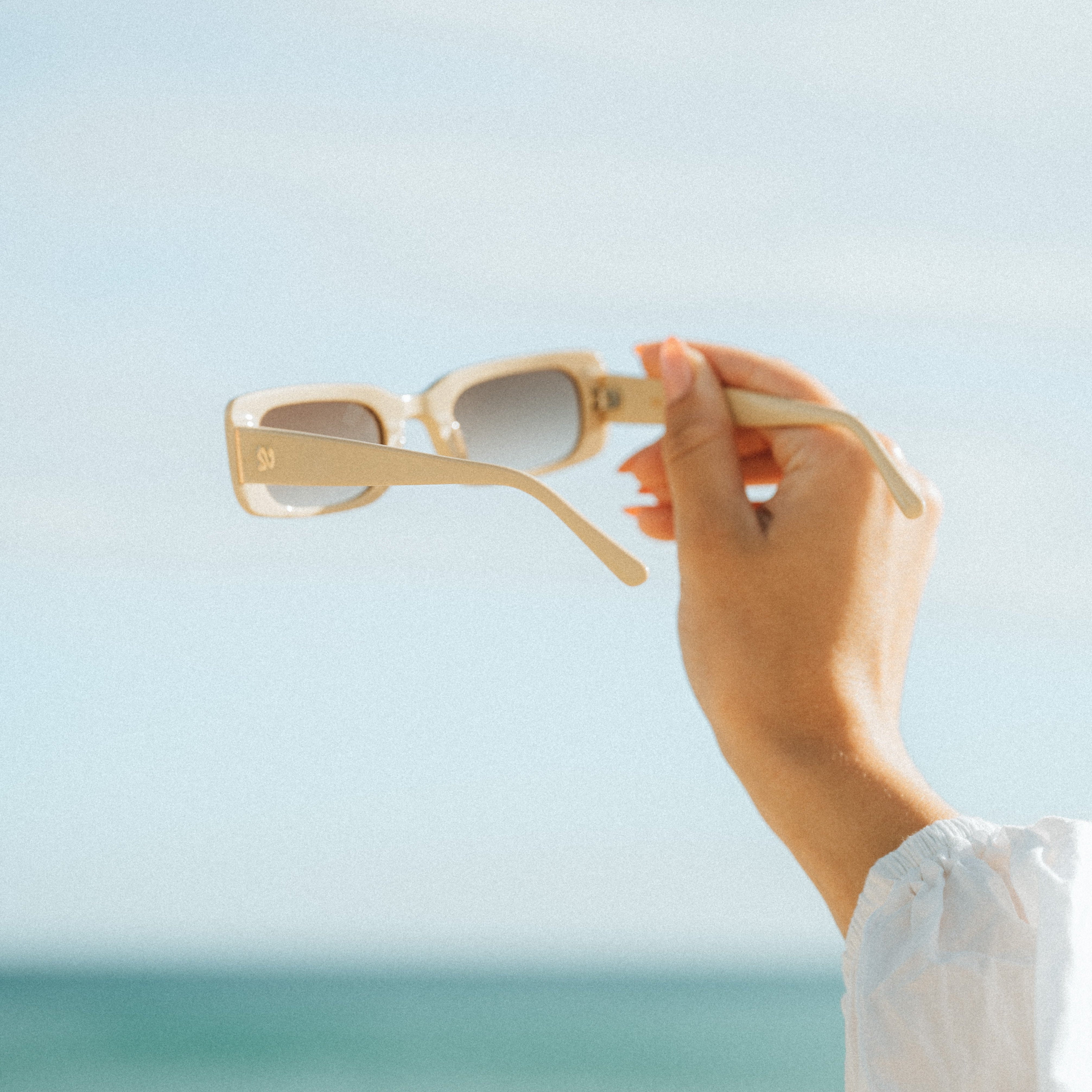 Product shot of Isla Sunwear sand rectangular sunglasses, designed for smaller faces.