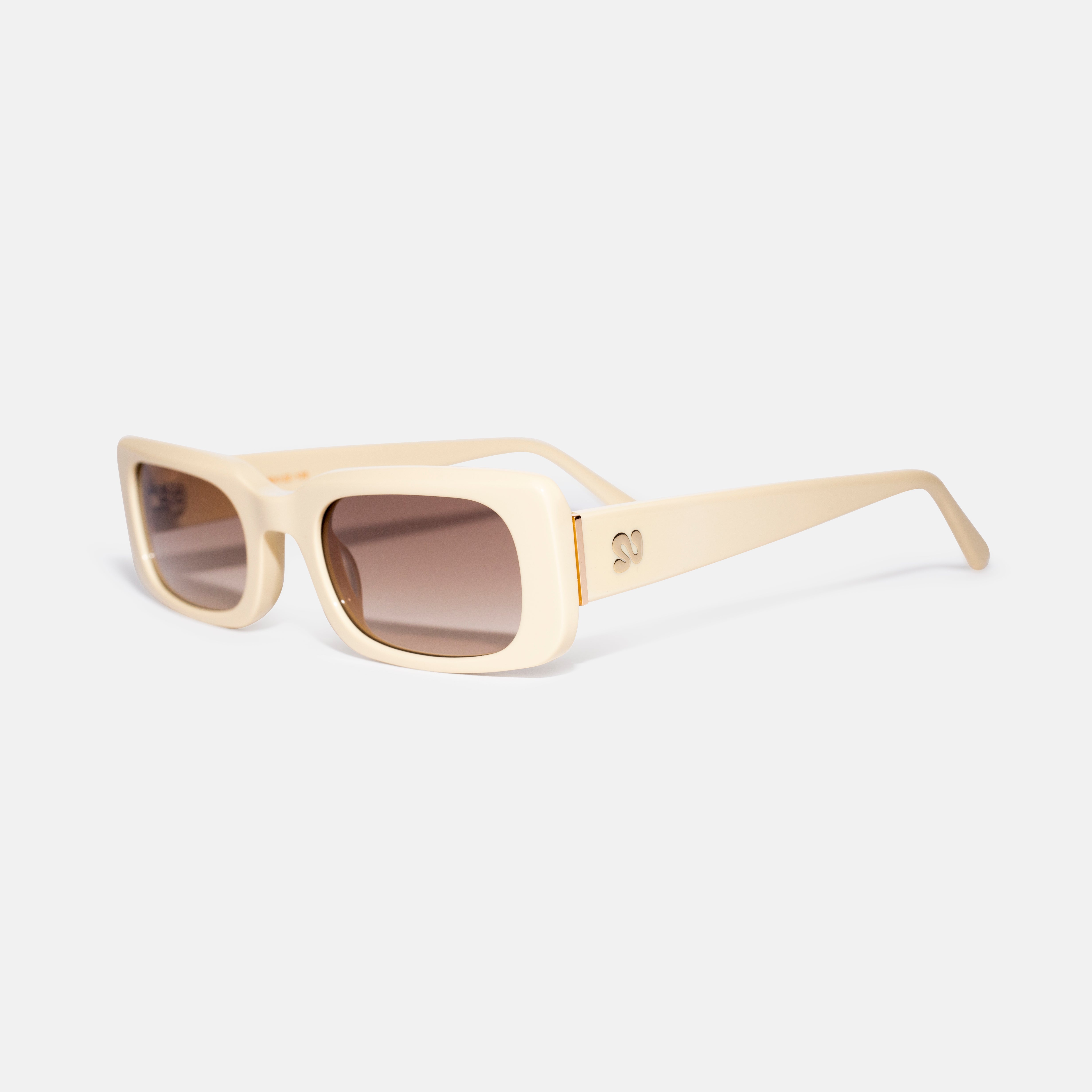 Side angle of sand-colored rectangular sunglasses showing temple detail, designed for smaller faces by Isla Sunwear.
