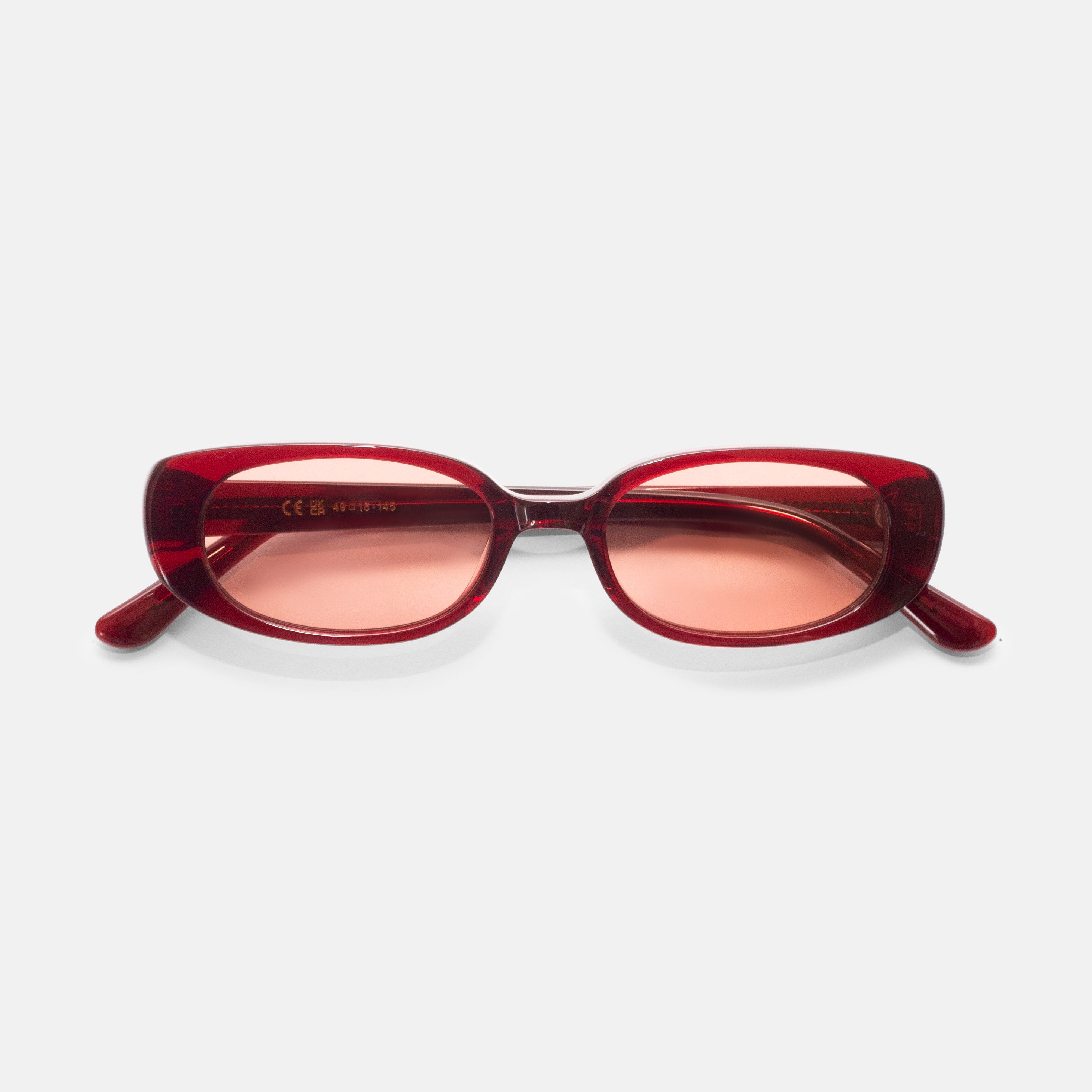 Front view of cherry red oval sunglasses designed for smaller faces by Isla Sunwear.
